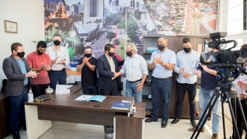 Romulo Quintino (ao centro, de terno escuro) é cumprimentado pelo vice-prefeito Renato Silva logo após assinar o termo de posse