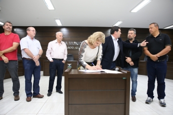 A vereadora Nadir Lovera assina o termo de posse no gabinete do presidente Alécio Espínola